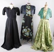 A 1940s eau de Nil full length crepe dress; together with a green and black 1950s taffeta skirt, a