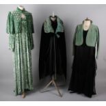 A 1930s black taffeta gown with tiny rosebud design; with a 1930s green velvet shoulder cape, a