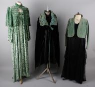 A 1930s black taffeta gown with tiny rosebud design; with a 1930s green velvet shoulder cape, a