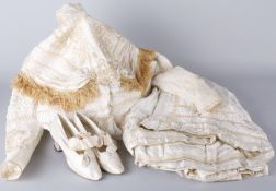 A late 19th century two-piece wedding outfit, comprising: a high-necked, pleated cream silk blouse