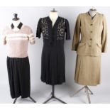A 1930s lime green satin cowl neck dress; a 1940s black crepe dress, a tweed green and brown 1940s
