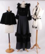 A black velvet and cotton layered evening dress trimmed with feathers; an ermine fur stole; a 19th