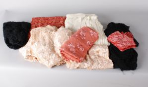 A large unused bolt of coral silk velvet devore fabric; with a collection of pale pink devore pieces