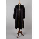A Chinese midnight blue silk winter coat, lined with sheepskin, having a Mandarin collar, side vents