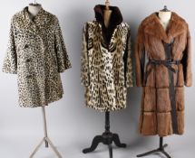 A 1960s Astrakhan coat; together with a pale mink jacket, a 1970s fur and leather coat, a grey
