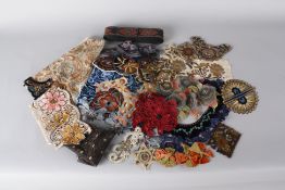 A quantity of early 20th century embroidered and woven trimmings and motifs, suitable for