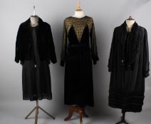 Six items of ladies evening costume, comprising: a 1920s coat with faux fur collar, a 1940s black