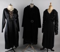 A 1920s black velvet evening coat with diamante buckle, a black satin dress with sequin detail to