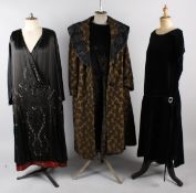 Six items of ladies costume from the 1920s including: a brocade evening coat, a beaded black satin
