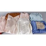 A collection of ladies lingerie from the 1920s to the 1960s, including: a russet coloured sateen