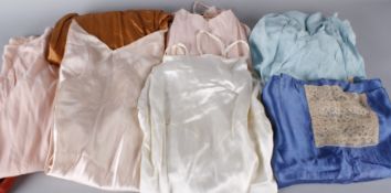 A collection of ladies lingerie from the 1920s to the 1960s, including: a russet coloured sateen