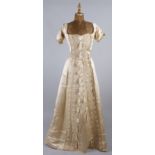 A 19th century cream satin and lace dress decorated with tassels; together with a late 19th