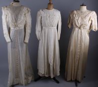 A selection of Edwardian costume, comprising: a cream satin and lace dress; a silk dress by R.E.