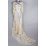 A 1930s tulle and beaded wedding gown; together with a 1940s cream lace wedding dress and slip, a