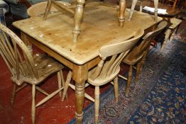 An old pine kitchen table,raised on turned supports.