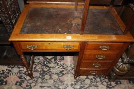 A late Victorian mahogany desk with inset writing surface and five short drawers 91cm wide