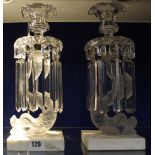 A pair of clear and frosted glass table lustres, with dolphin columns and marble bases, 31cm high