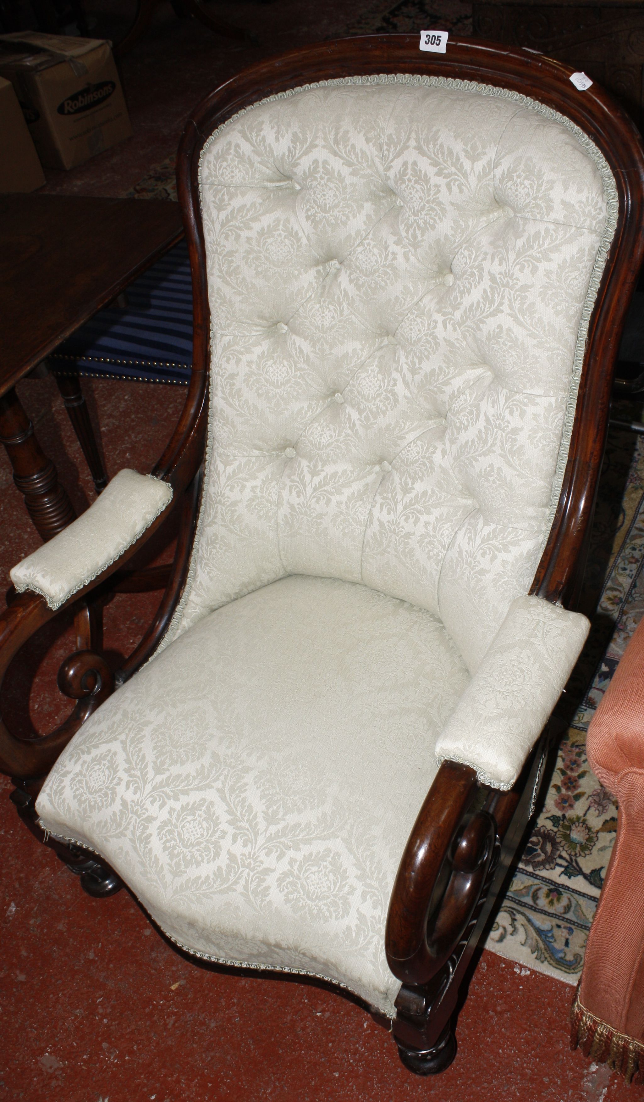 A Victorian mahogany framed button back open armchair, on turned legs, with upholstered seat, back