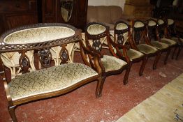 A set of six late Victorian mahogany drawing room chairs with upholstered seats and panel backs,