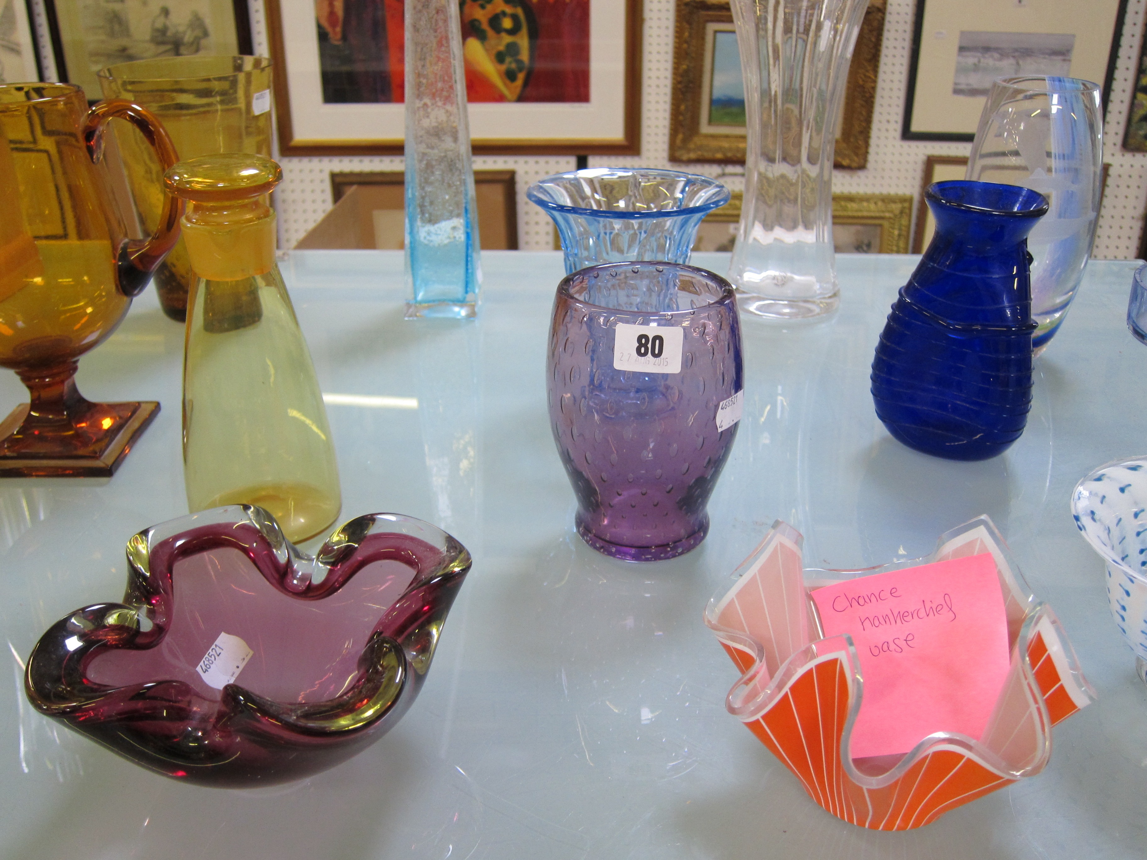 A quantity of art glass to include a Caithness dolphin patterned vase, a Bristol blue shaped vase, a