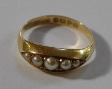 An 18ct gold ring set with five graduated pearls, ring size O approx.