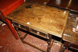 An oak side table, 17th century and later adapted with two frieze drawers 84cm wide