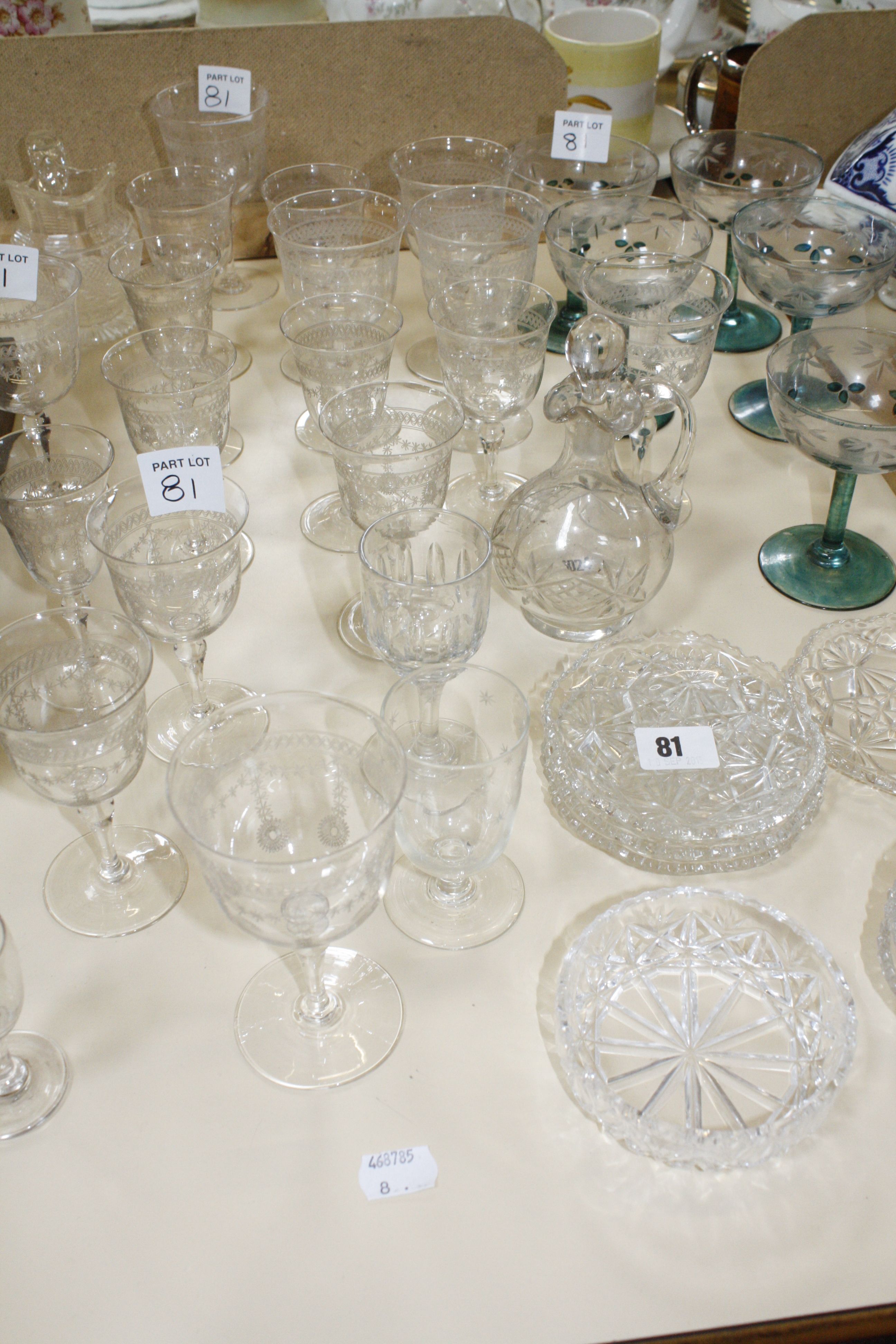 A quantity of clear glass wines, with etched decoration, and other items of glassware