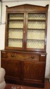 A Regency mahogany secretaire bookcase with brass grill doors to the upper section over a fitted