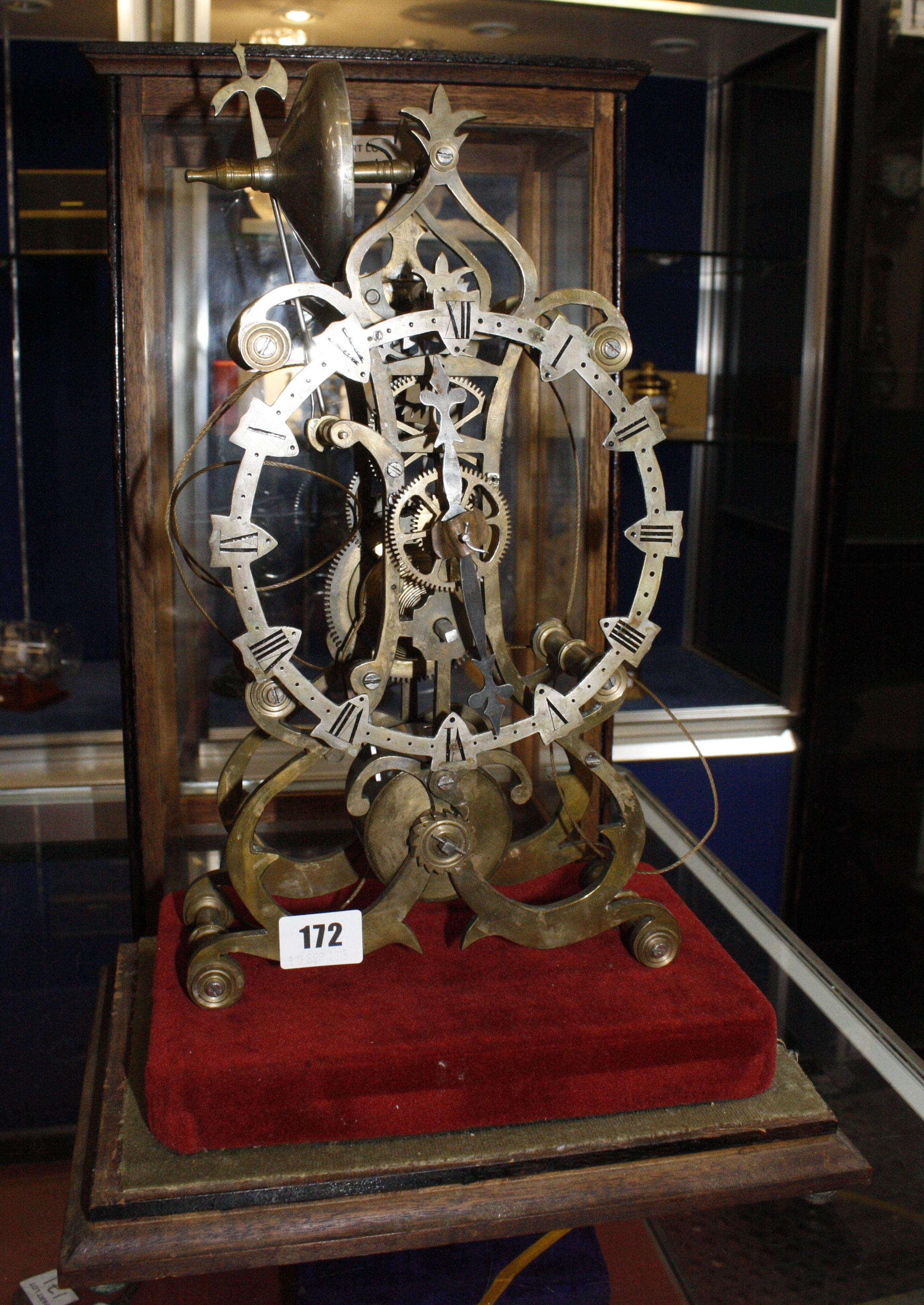 A skeleton clock (partially dismantled) with a later glazed case