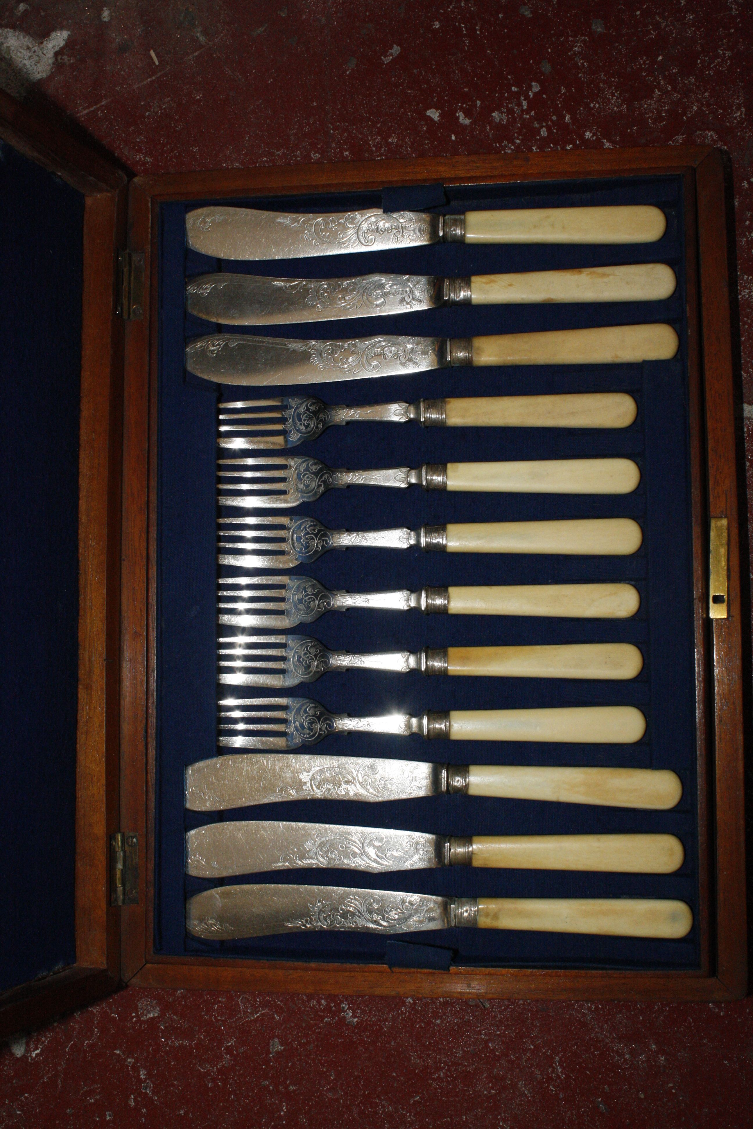 A boxed set of twelve silver-plated fish knives and forks, late 19th century, in an oak case; a - Image 2 of 2