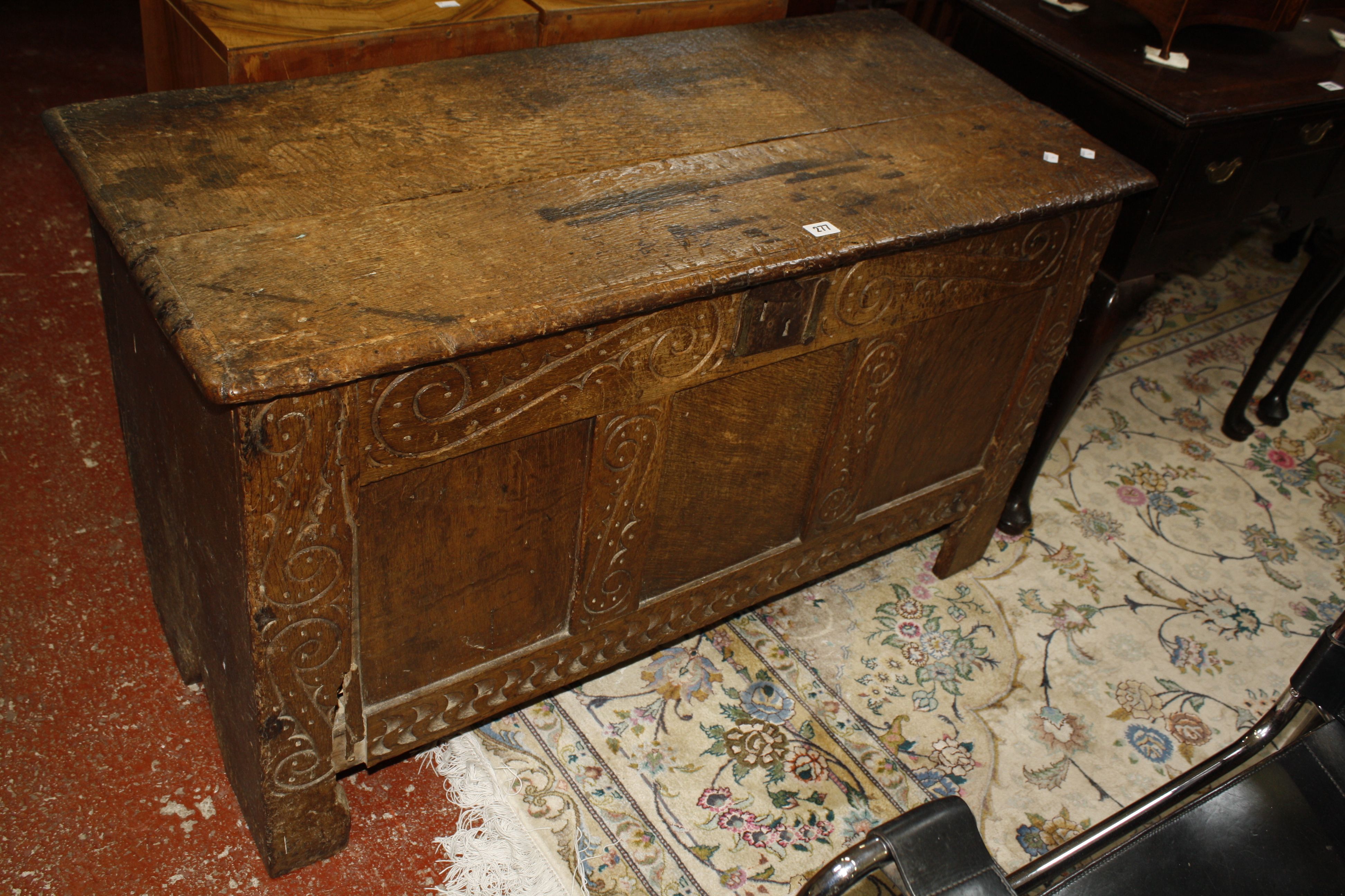 A 17th Century carved oak panelled chest 111cm wide