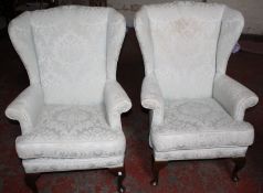 A pair of wing armchairs