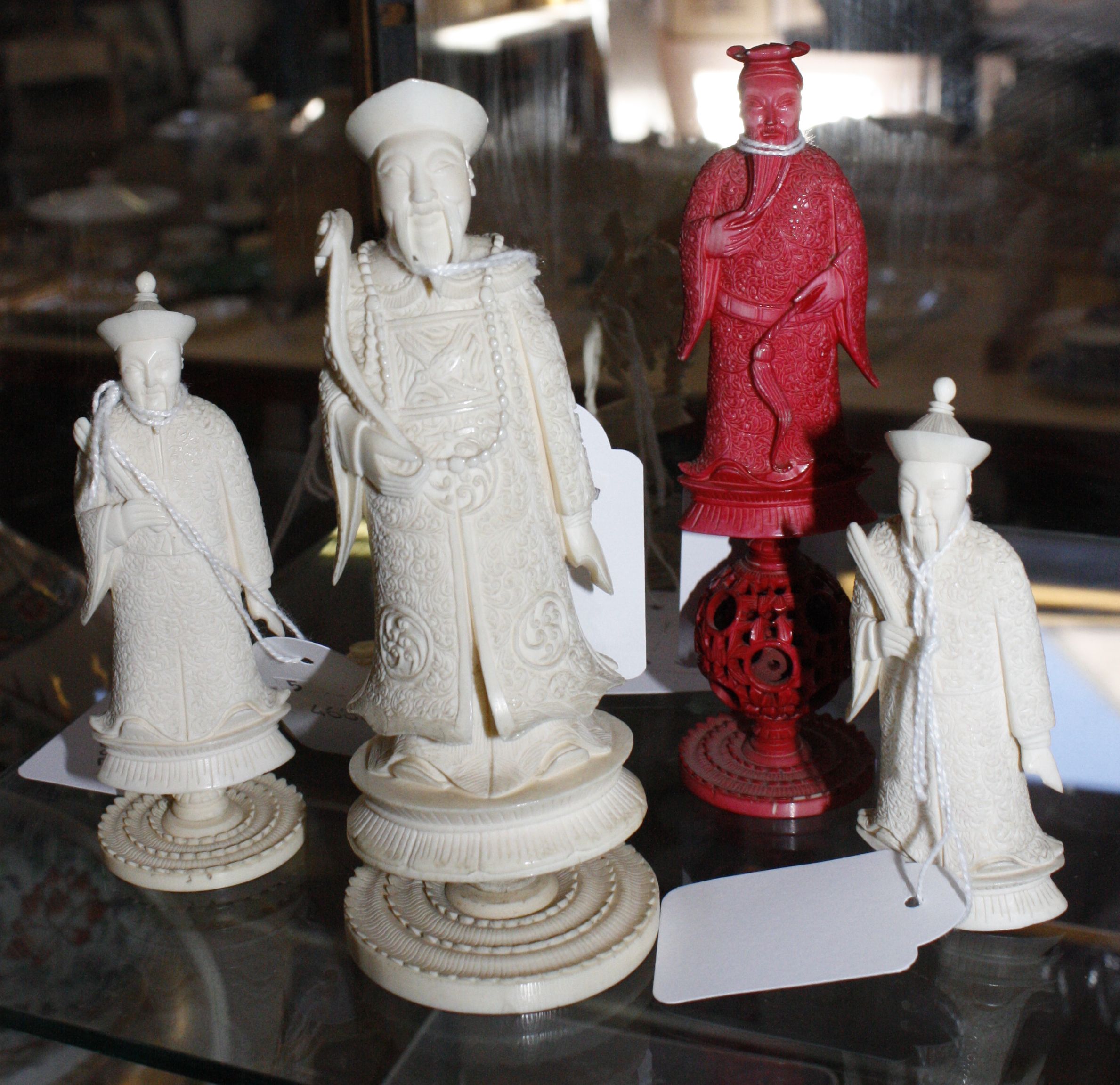 A set of six carved ivory Chinese figures (from a chess set) (one stained red figure) (af)
