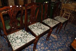 A set of four Chippendale style dining chairs with pierced splat backs, lift out seats, on