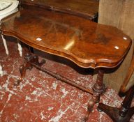A Victorian walnut occasional table of serpentine outline on turned legs, carved scroll feet, 112cm