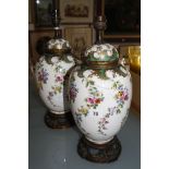 A pair of ceramic vases with covers, converted into table lamps, floral decorated (sold as parts)