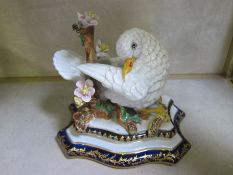 A Sevres porcelain dove, on branch, with mark to base, 13cm high approx and a pair of porcelain