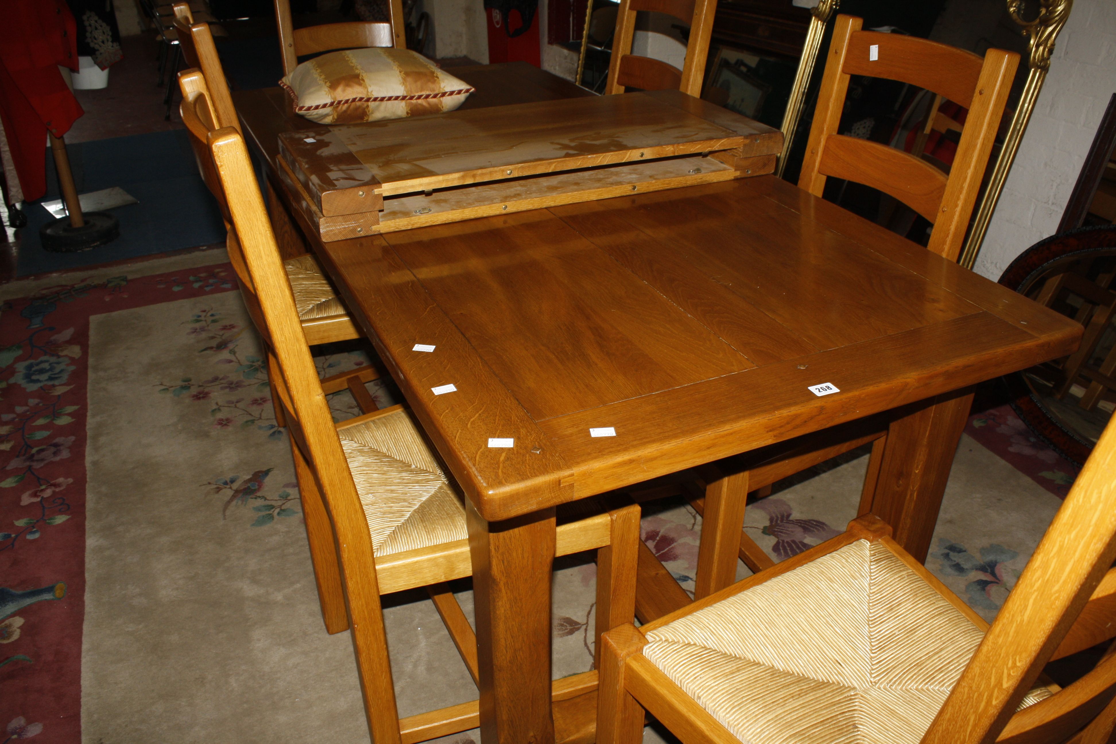 A modern refectory type oak extending dining table, with two additional leaves,  together with a set