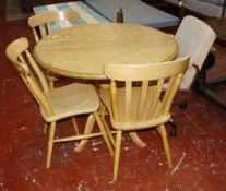 A circular beech kitchen table 99cm diameter and three chairs and an office swivel chair.  Best Bid
