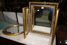 A gilt triptych dressing mirror, further oval example and a full length mirror