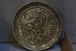A cinnabar lacquer dish with a dragon and a phoenix, now painted gold, 20cm, Ming mark