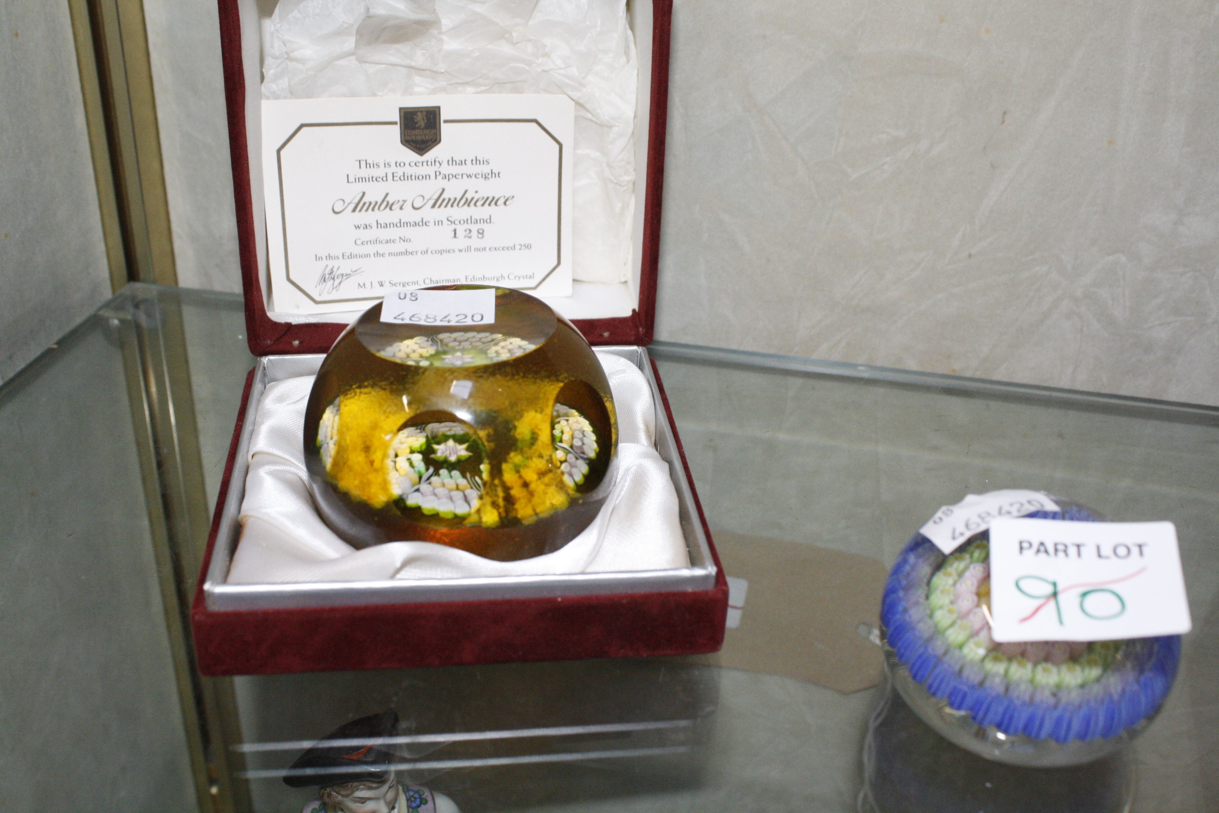 Two Edinburgh paperweights, a Langham paperweight, two other paperweights and a glass bird whistle