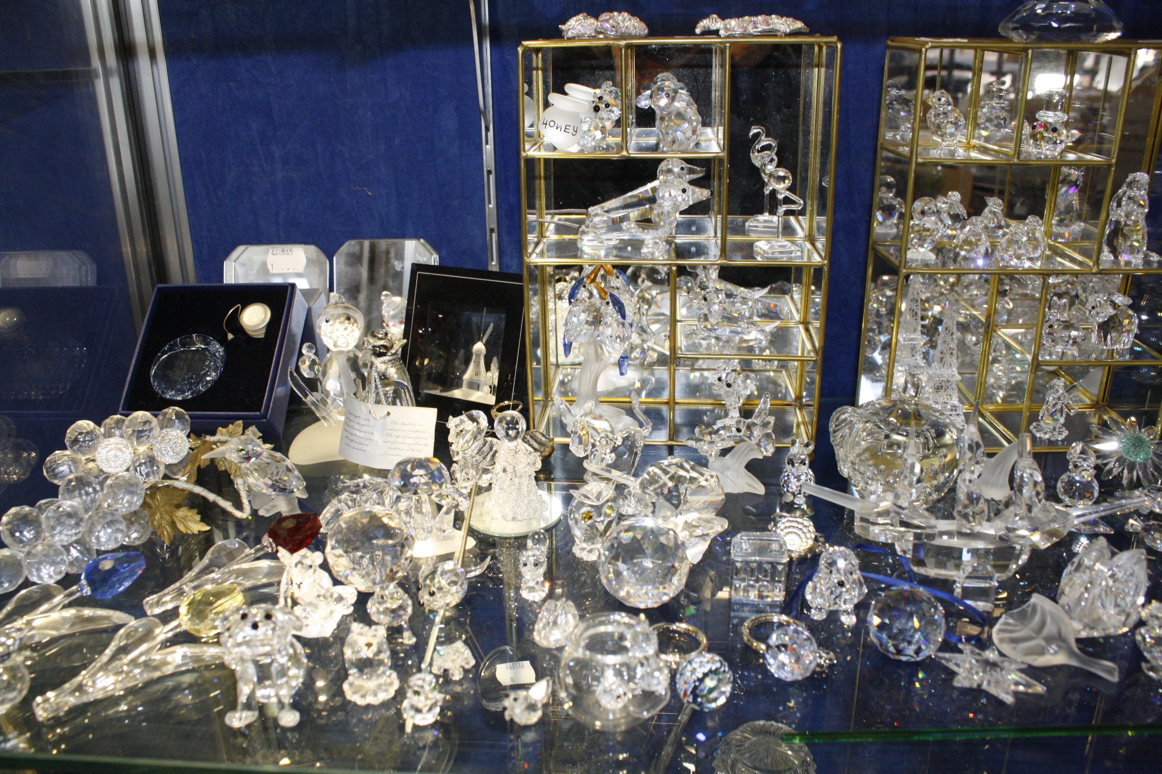 A quantity of Swarovski glass models and three display cabinets, (qty)