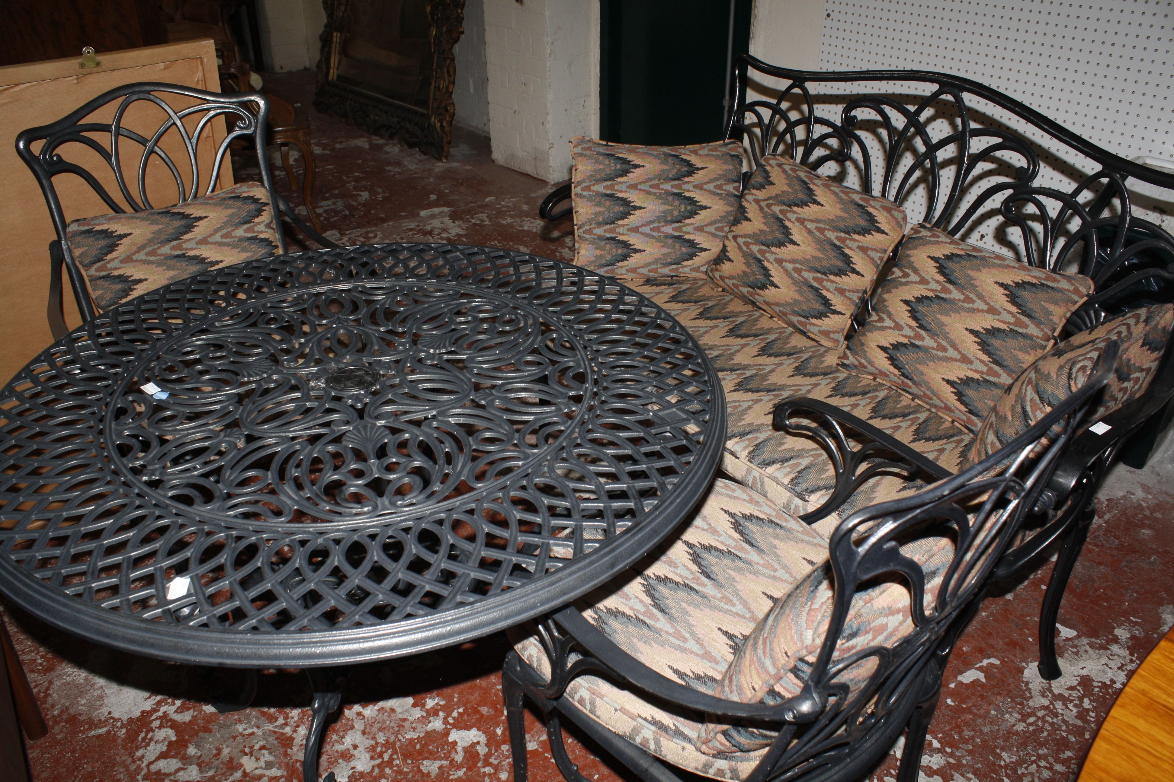 Metal garden furniture to include a table, pair of chairs and bench