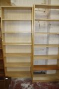 Three tall wood finished bookcase and two half size bookcases all with adjustable shelves.  Best