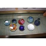 Eight assorted glass paperweights plus a quantity of coloured stone eggs