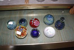 Eight assorted glass paperweights plus a quantity of coloured stone eggs