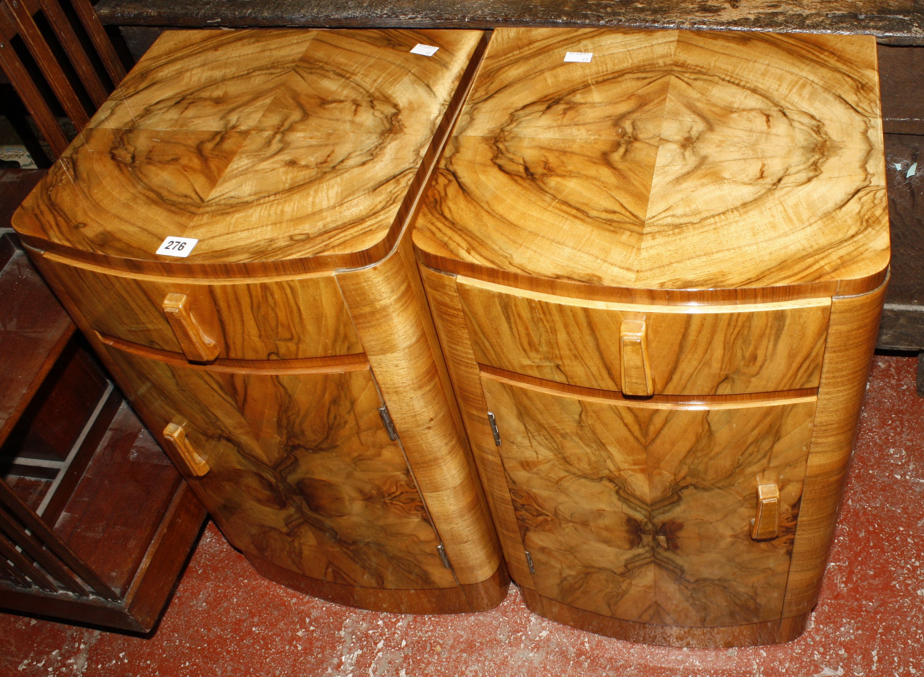 A pair of Art Deco style walnut bowfront bedside cupboards  Property of the Late Christopher