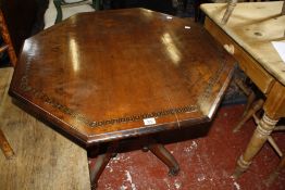 A Victorian mahogany octagonal centre table, on reeded turned  pillars and four reeded sabre legs,