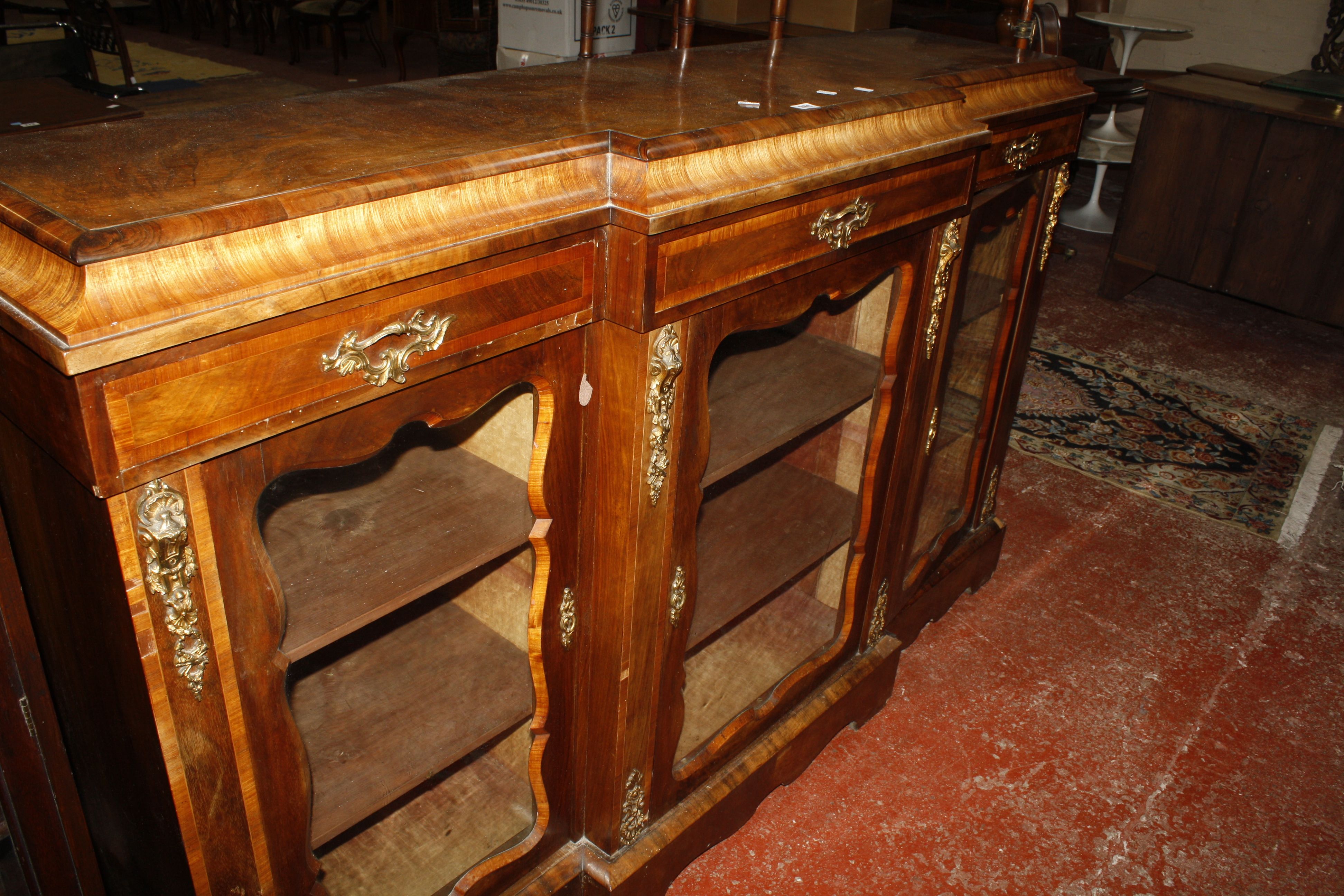 A Victorian walnut and crossbanded, gilt metal mounted breakfront display cabinet, with three